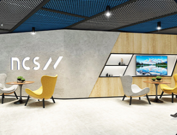 Contemporary NCS corporate office interior featuring a striking geometric wall design with bright, ambient lighting.
