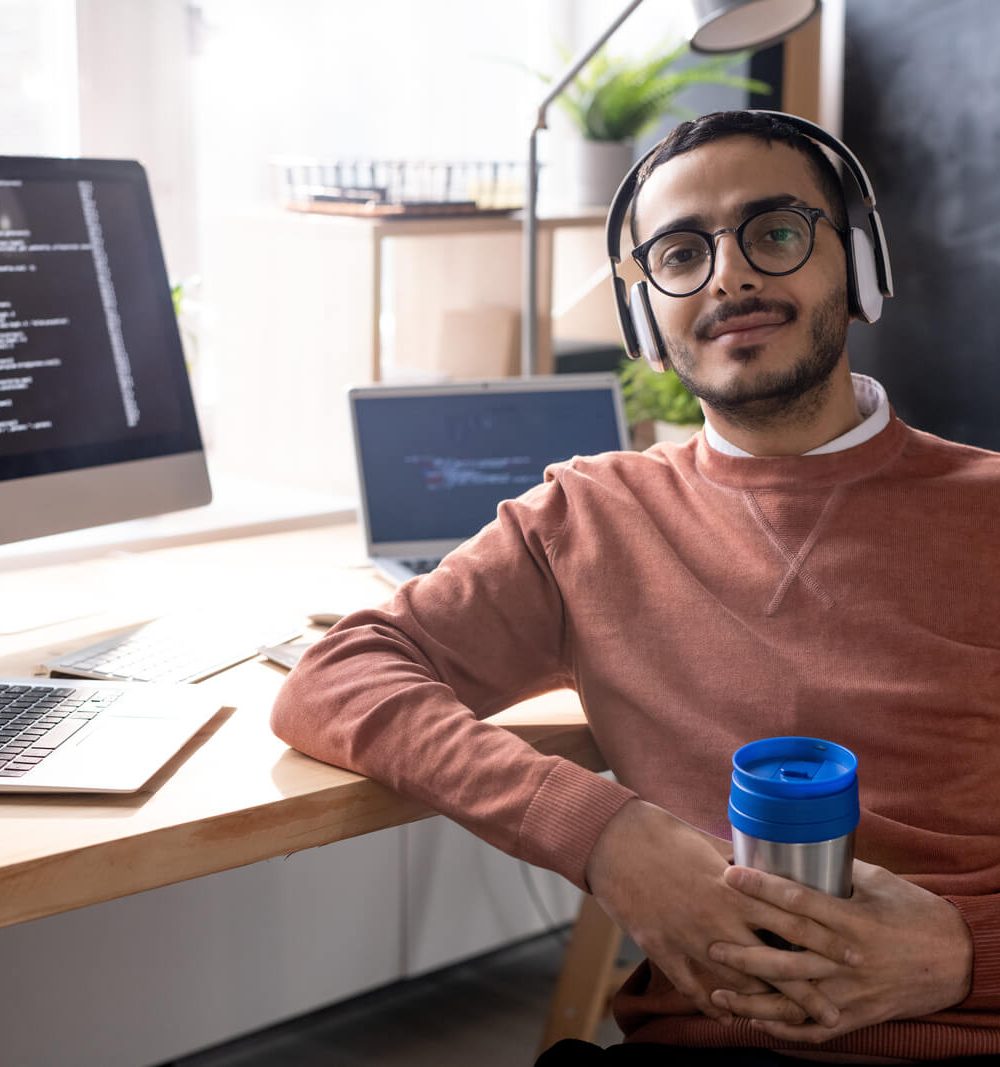 handsome-programmer-in-headphones-listening-to-mus-2023-11-27-04-56-48-utc
