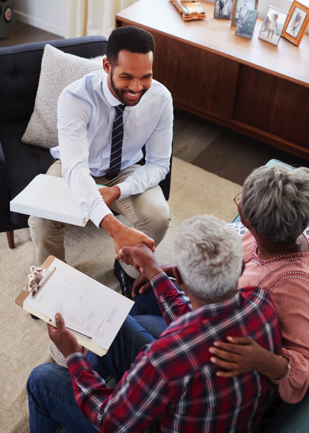 senior-couple-shaking-hands-with-male-financial-ad-8EXRPDY-1.jpg